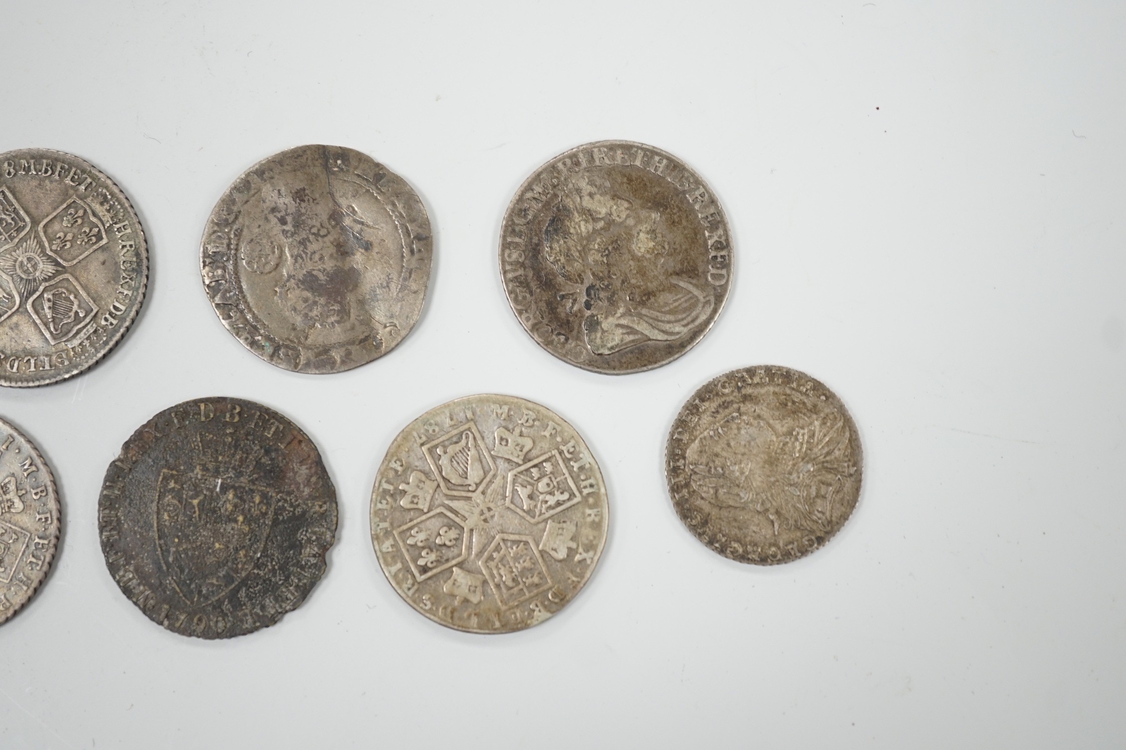 Four 18th century shillings, a sixpence an Elizabeth I coin and a token